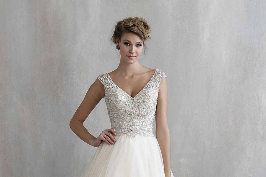 Style MJ206 <br> Structured yet soft, this gown incorporates a uniquely embroidered bodice and scalloped edging.