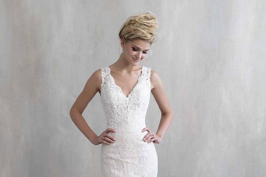 Style MJ204 <br> This distinctive gown features delicate lace leading to an illusion back, edged with a floral motif.