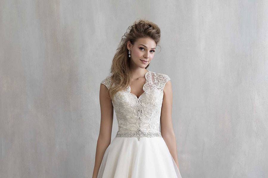 Style MJ206 <br> Structured yet soft, this gown incorporates a uniquely embroidered bodice and scalloped edging.