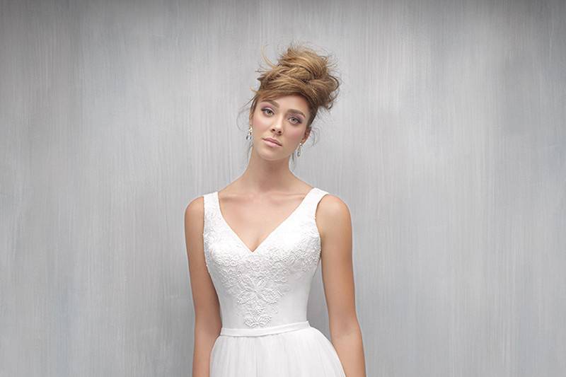 Style MJ261 <br> This gown pairs a soft A-line skirt with a delicately embroidered sleeveless bodice.