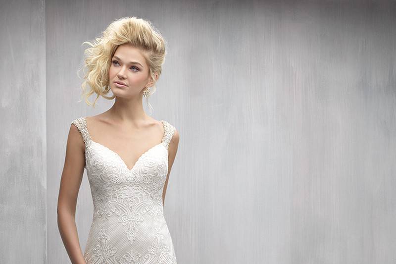 Style MJ270 <br> The highlight of this lace gown is the subtle, crisscrossed beadwork along the back.