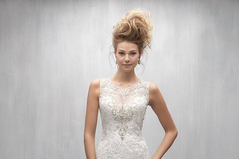 Style MJ252 <br> Bold patterned lace appliques pair perfectly with this chic gown's ruffled train.