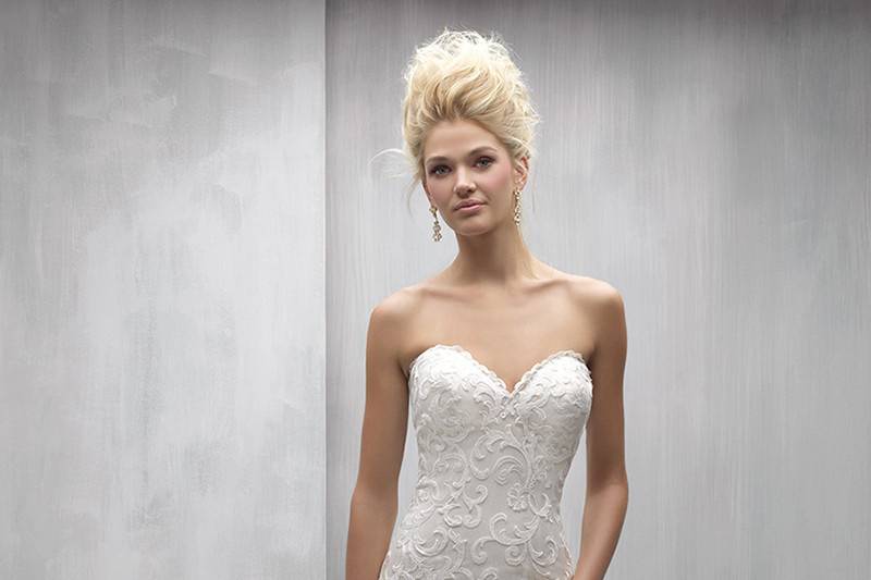 Style MJ252 <br> Bold patterned lace appliques pair perfectly with this chic gown's ruffled train.
