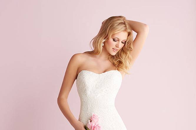 Style 2700 <br> This strapless all-lace gown features a soft mermaid silhouette and a removable lace bolero. 