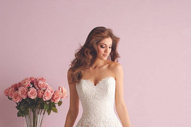 Style 2700 <br> This strapless all-lace gown features a soft mermaid silhouette and a removable lace bolero. 