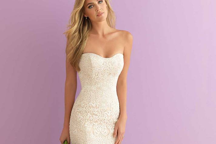 Style 2903 <br> Strapless, curve-emphasizing and beautifully subtle, this lace gown is a dream come true. The chapel train features covered buttons from top to bottom. 