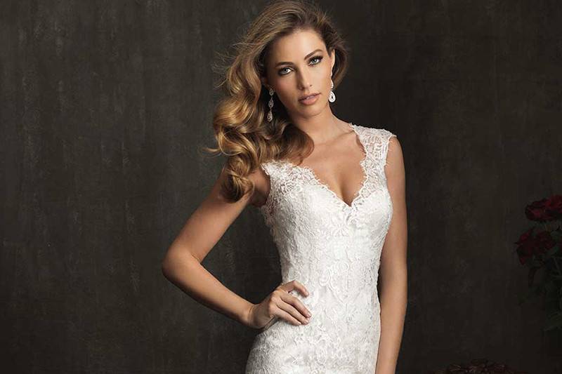 Style 9068 <br> A sexy and sophisticated style in all-over lace. This slim gown features a V-shaped neckline with delicate cap sleeves. The true beauty of this style is the dramatic back. 