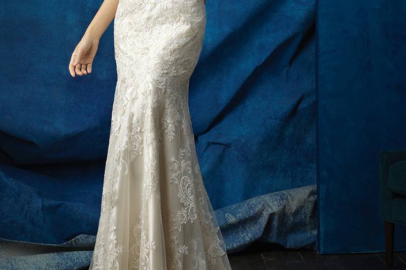 Style 9367 <br> A delicate cap sleeve and patterned back add something special to this curve-hugging lace gown.