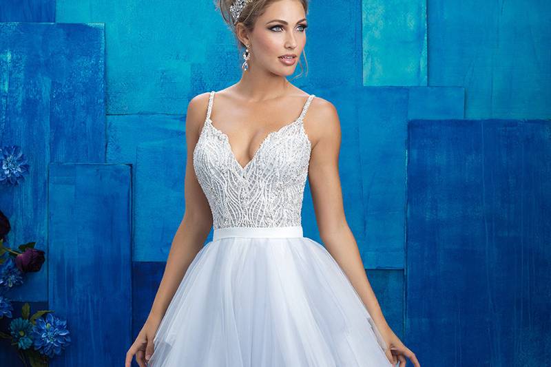 9424	<br>	The lace overskirt of this sheath gown is topped with an illusion neckline, back and sleeves.