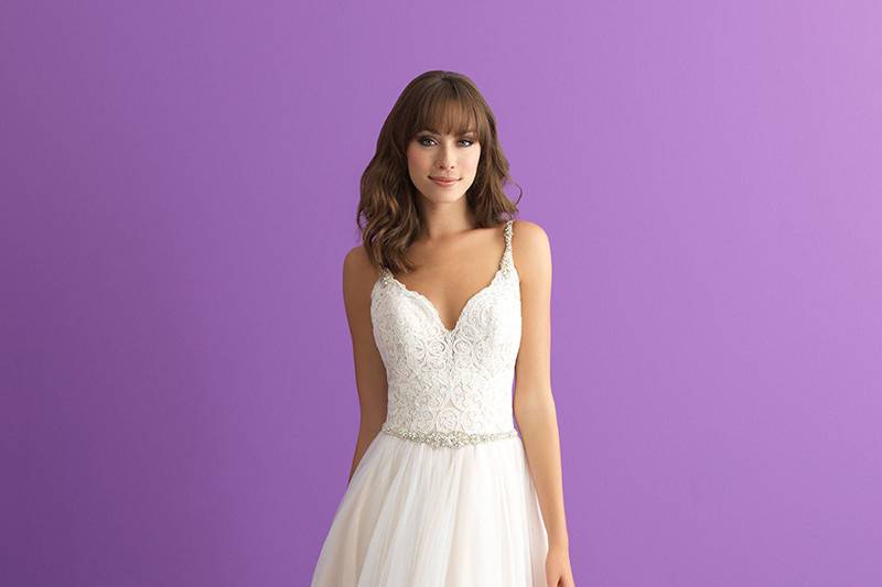 Style 3003		Delicate lace frames the deep sweetheart neckline and illusion back on this cap sleeved gown.