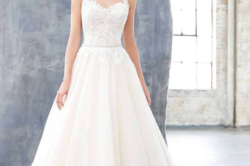 Style MJ303		Floating button enclosures and delicately scalloped lace create a truly unique bridal gown.