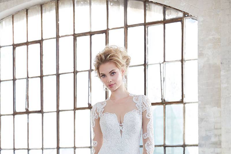 Style MJ309		Illusion sleeves offset the demure lace of this sheath gown.
