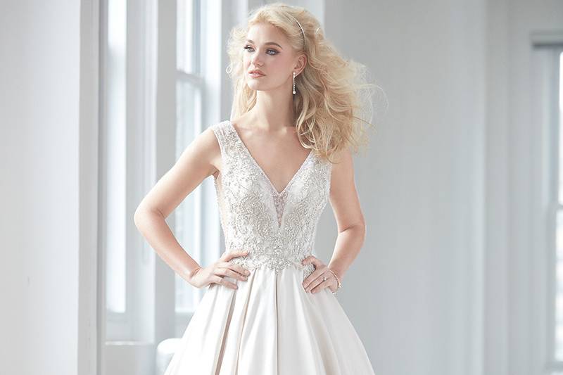 Allure Couture STYLE: C248 <br>
This gown has a flattering sweetheart neckline and a dropped waist bodice adorned with rich embroidery, Swarovski crystals, and sheer illusion detail. The ball gown skirt features dramatic ruffles.