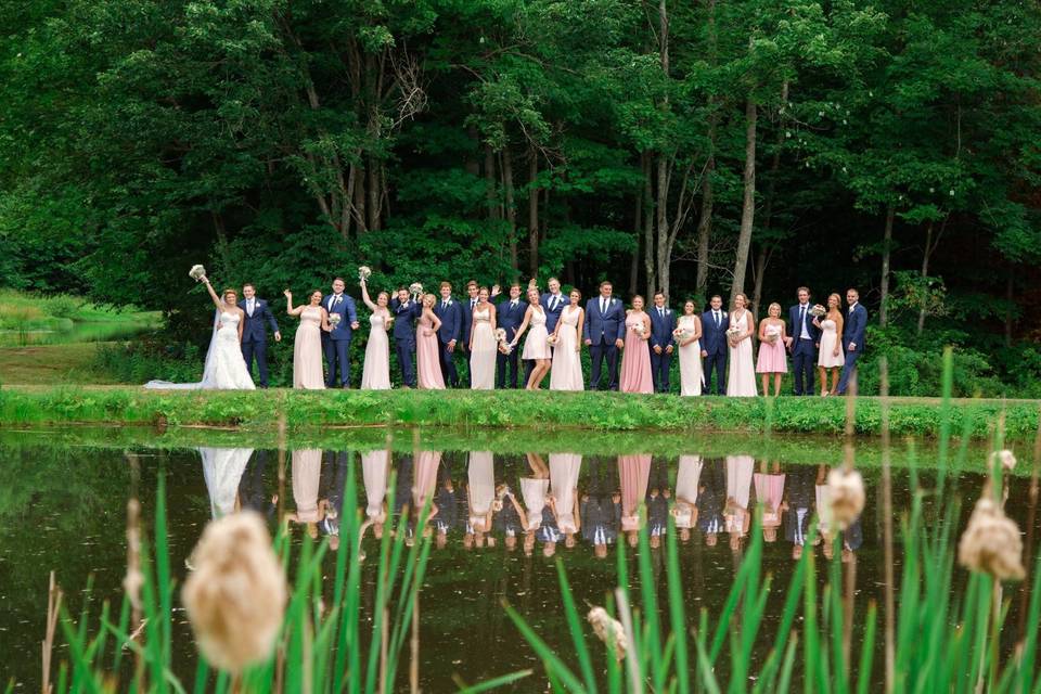 Newlyweds and their guests by the pond