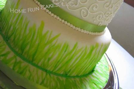 Hand-painted grass themed wedding cake, with royal icing scrollwork and french dotting.