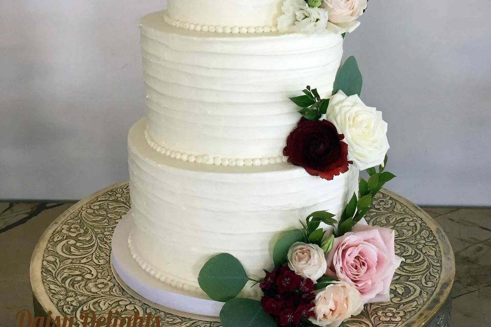 3 tier buttercream brush wedding cake with fresh floral