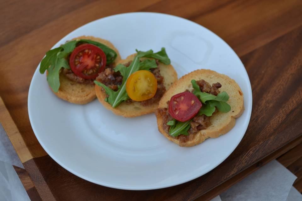 BLT Crostini– toasted Italian Baguette topped with Brie, Bacon Jam, Arugula, and Cherry Tomato