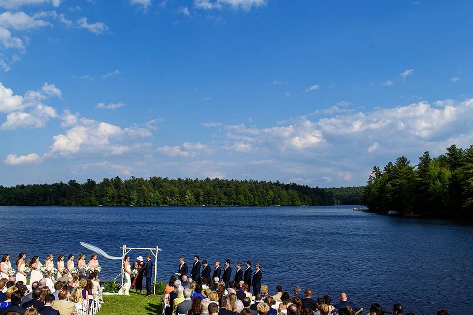 Outdoor ceremony by lake.