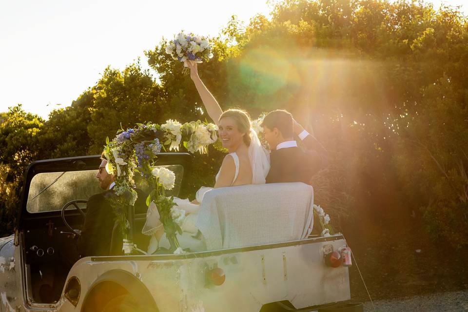 Waving bouquet from a jeep