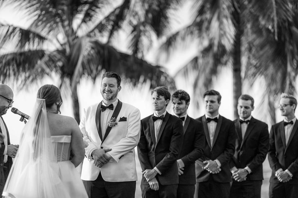 Groom smiling during vows