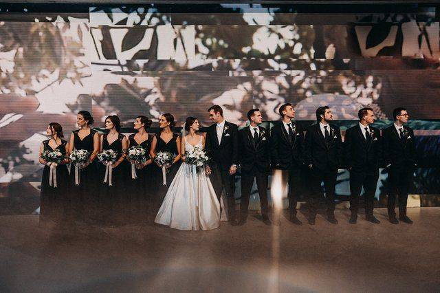 Bridal party in front of project wall