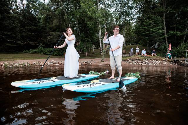 Bride groom paddleboarding