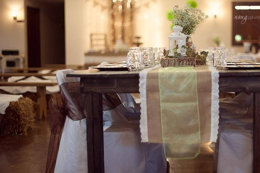 Rustic Farm Tables with Burlap Runners and woodcut mason jar centerpieces are perfect. Brides can choose chair accent colors to fit their color scheme
