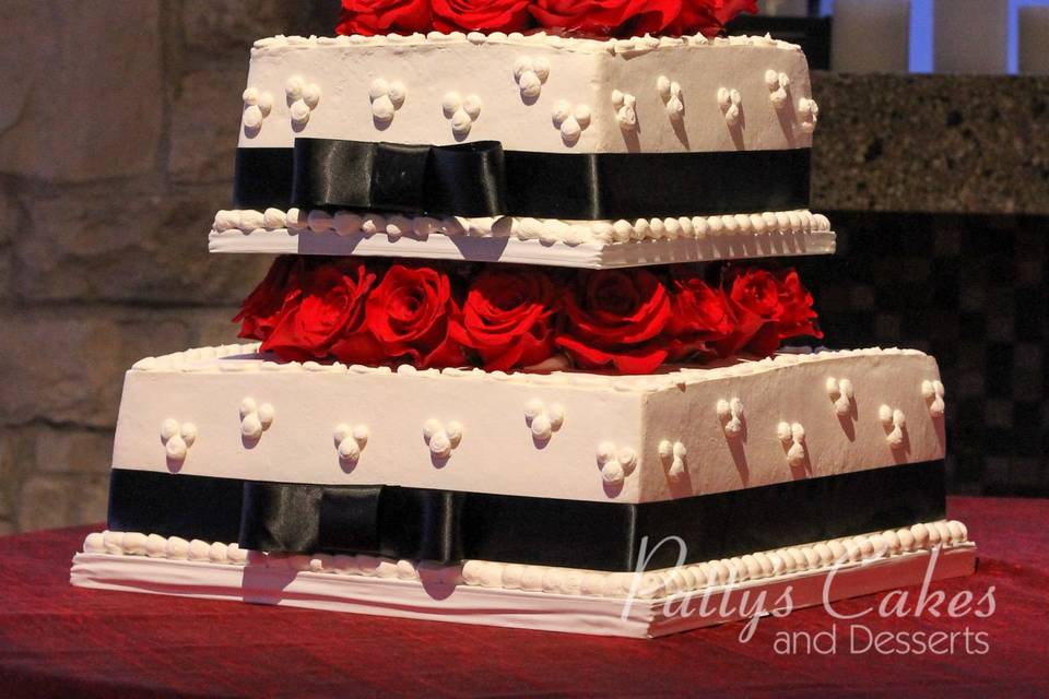 Wedding cake with black ribbons and red roses