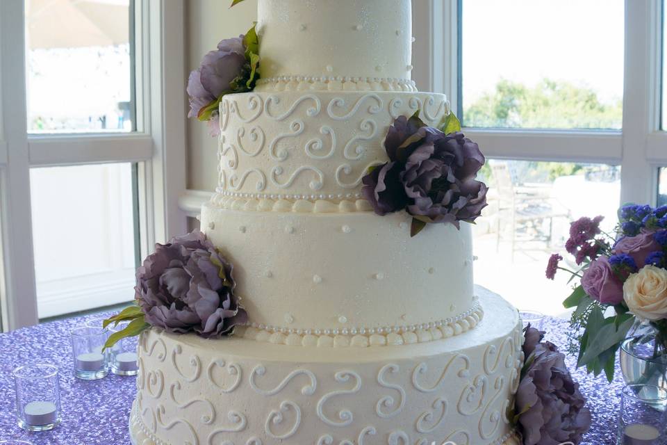 White wedding cake with purple flowers