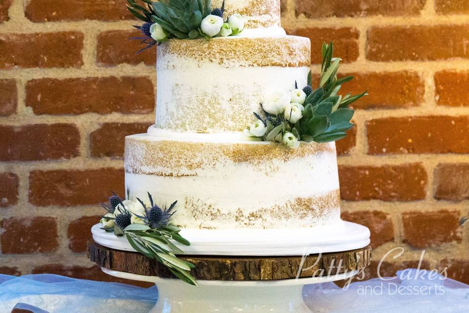 Naked wedding cake with greens