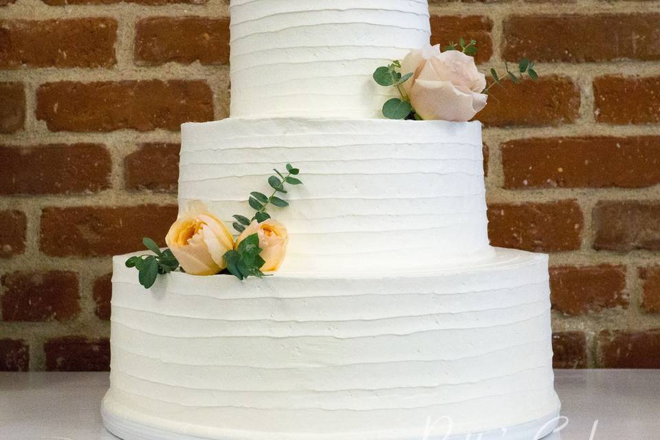 White wedding cake with yellow flowers