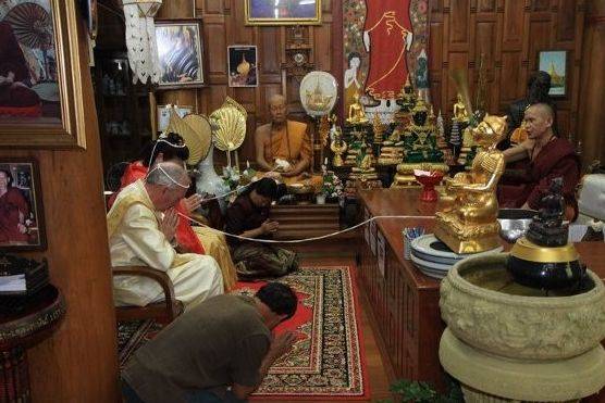 Buddhist temple blessing in teak wood temple