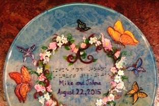 Wedding Plate with butterflies, sky blue background. Example of raised dot Braille, with Bride and Groom's names and wedding date.
