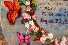 Wedding Plate with butterflies, sky blue background. Example of raised dot Braille, with Bride and Groom's names and wedding date.