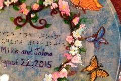 Wedding Plate with butterflies, sky blue background. Example of raised dot Braille, with Bride and Groom's names and wedding date.