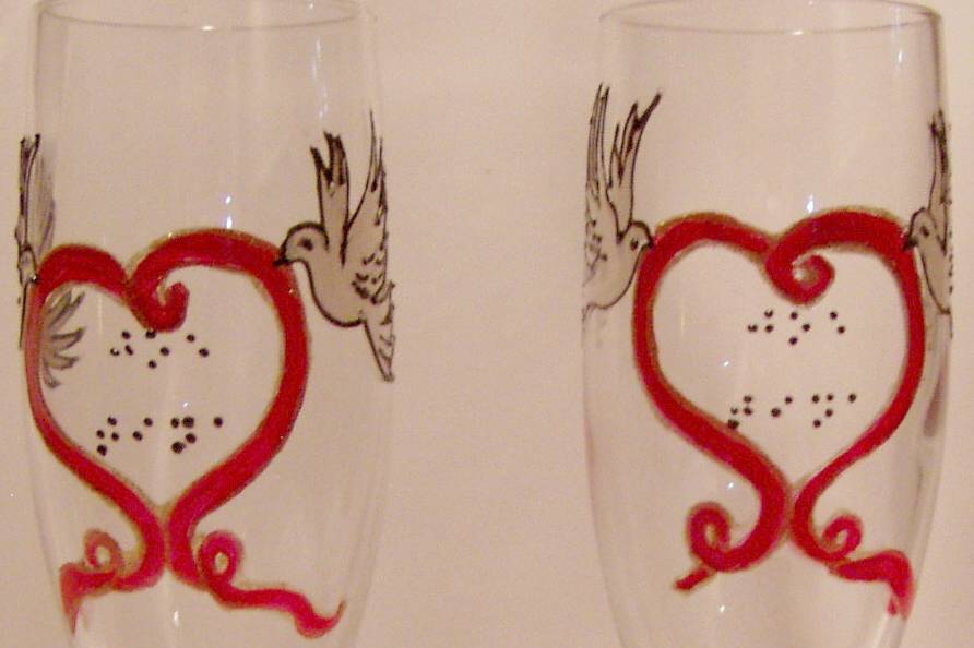Customer design request of doves with red ribbon making a heart. Name of the bride and groom is in raised dot Braille. Design is outlined so they could feel the birds and the heart shape. 45th year Anniversary!