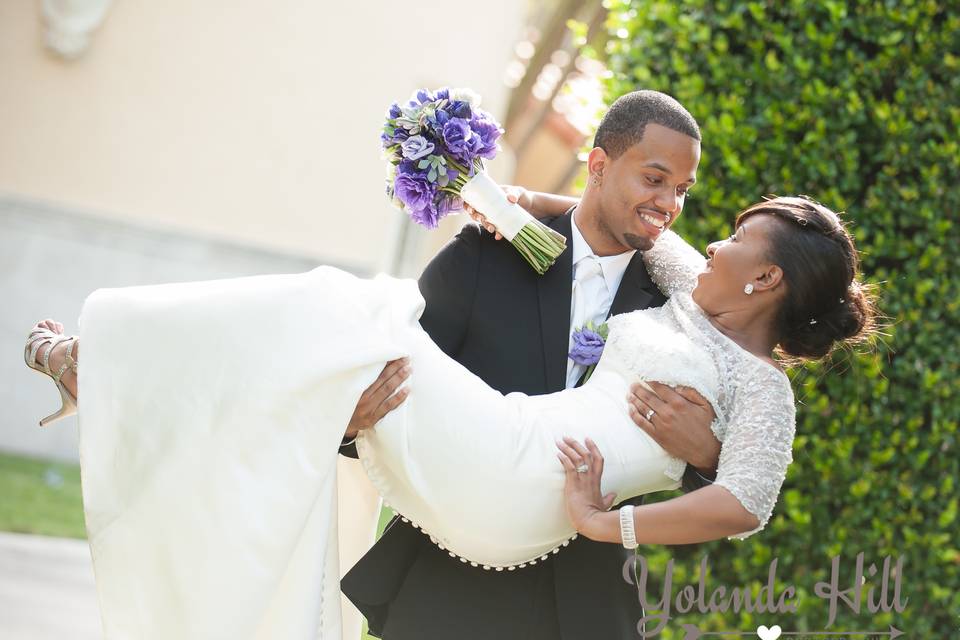 Groom carrying the bride