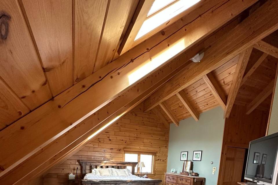 Primary suite in log chalet