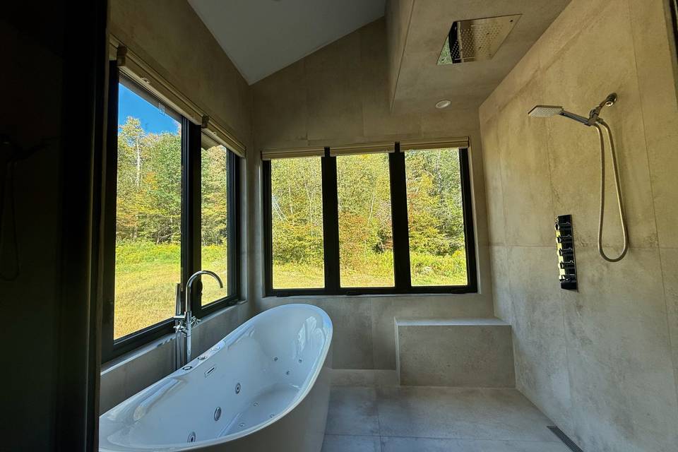 Primary suite bathroom and tub