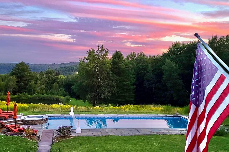 Sunset view of pool and spa