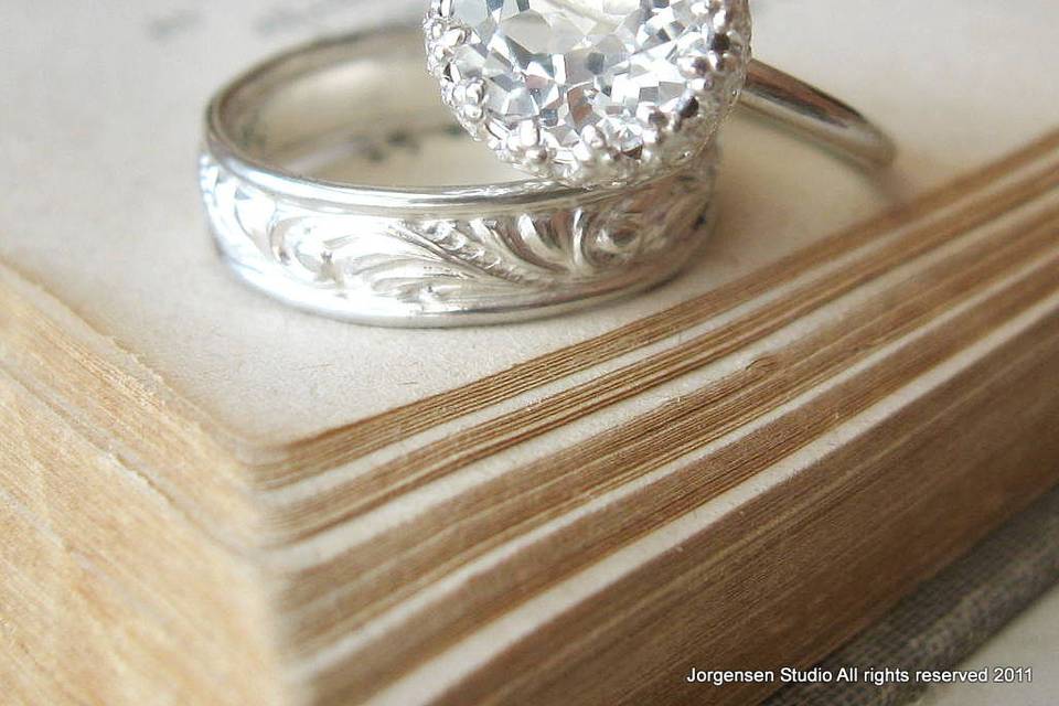 Handmade White topaz cake alternative engagement ring in Sterling silver. Unique and affordable. Sterling silver swirl band in the bright finish with thin rolled edge