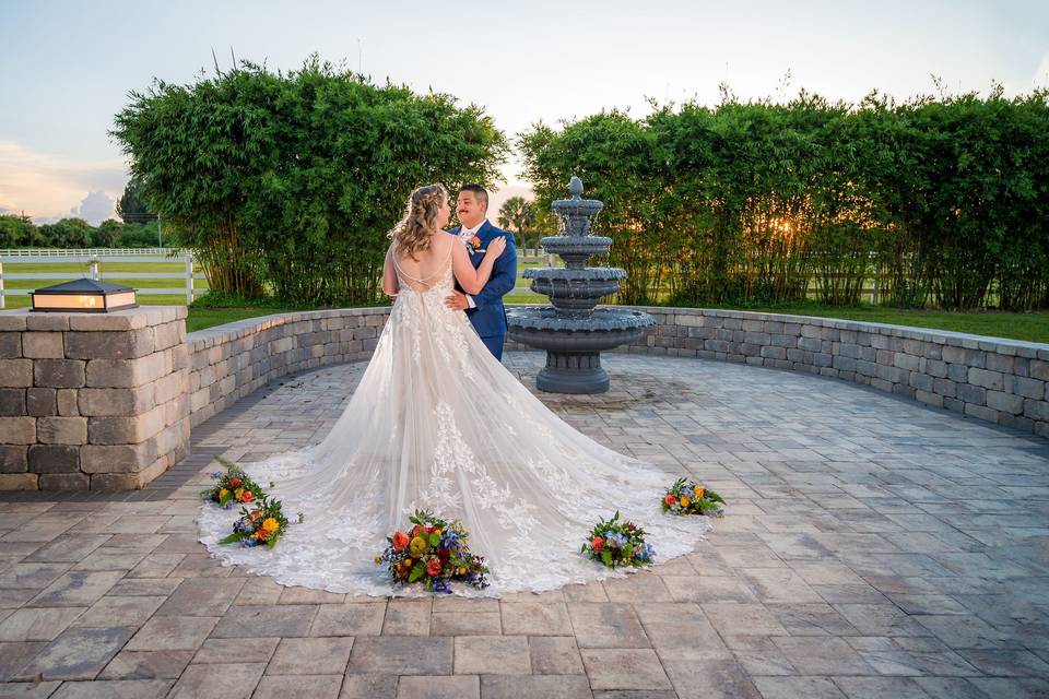 Bridal couple next to fountain