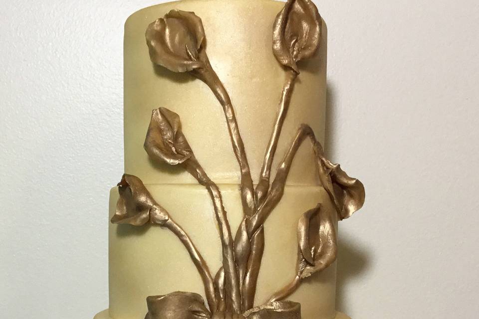 We made this simple and elegant 3 tiered gold cake with hand molded lilies.