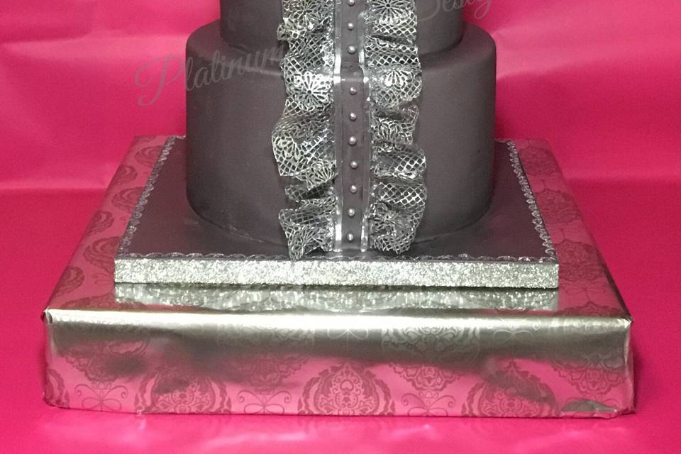 An elegant gray cake with delicate edible silver lace.  This cake mimics fashion forward dresses.