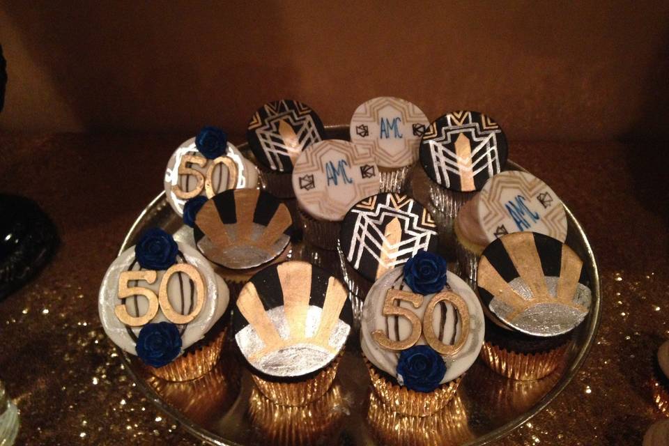 These Great Gasby-themed cupcakes are topped with buttercream frosting and fondant medallions that are hand painted.