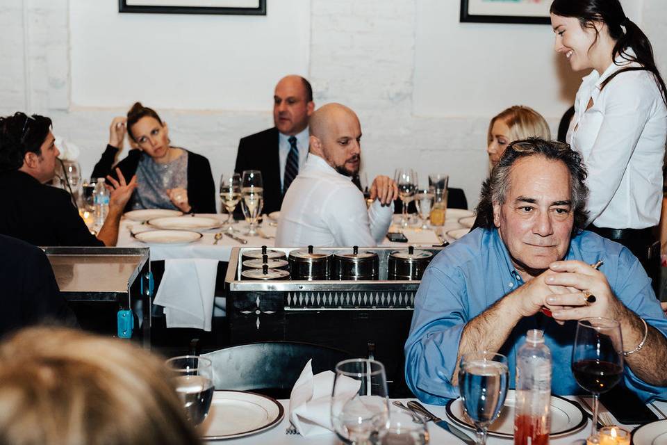 Guests seated at long tables.