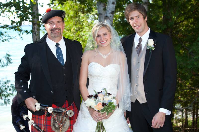 A pose with the newlyweds. Torch Lake in the background.