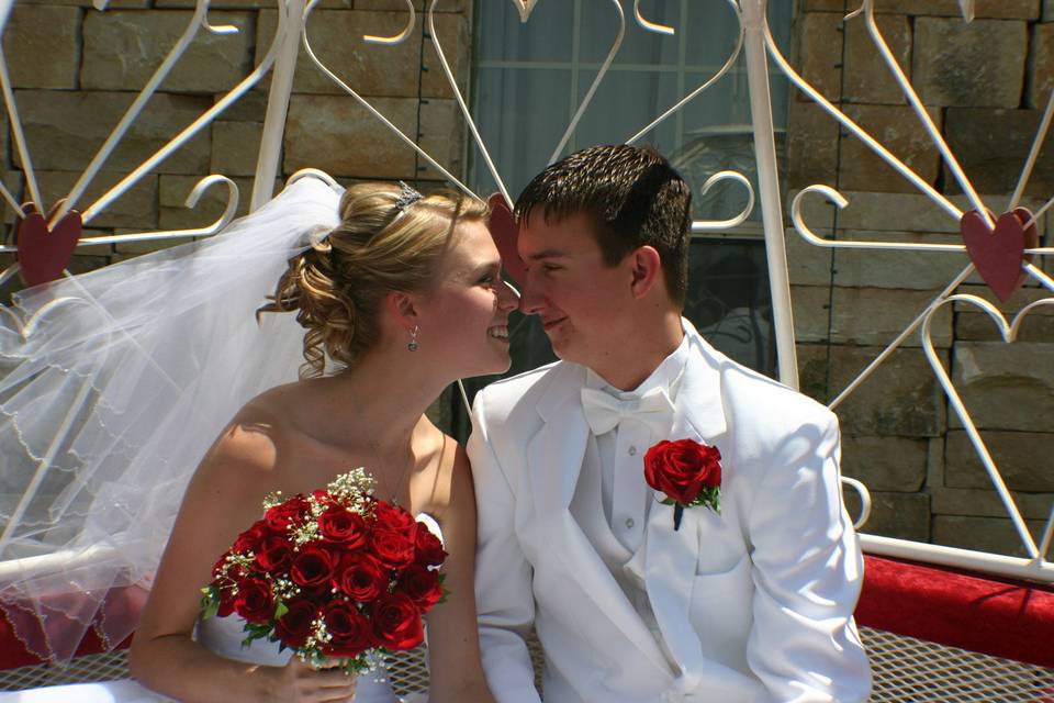 Newly weds kiss in a carriage