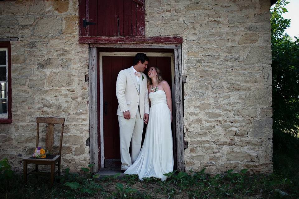 Wedding couple in the doorway of the rustic stone building