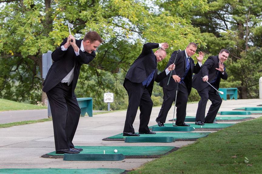 Bridal party posed on golf cart at country club wedding